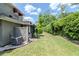 Home exterior with lush green lawn, privacy fence and air conditioning unit at 14053 Notreville Way, Tampa, FL 33624