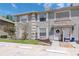 Two-story townhome exterior with neutral paint, shutters, and a decorative wreath on the front door at 14053 Notreville Way, Tampa, FL 33624