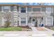 Charming townhome with well-maintained lawn, decorative door awning, and neutral color palette at 14053 Notreville Way, Tampa, FL 33624
