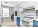 Bright kitchen with blue cabinets, tiled backsplash, and stainless steel appliances at 14053 Notreville Way, Tampa, FL 33624