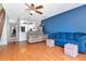 Open floor plan features hardwood floors, an adjacent staircase, and access to the kitchen at 14053 Notreville Way, Tampa, FL 33624