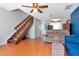Open floor plan features hardwood floors, an adjacent staircase, and access to the kitchen at 14053 Notreville Way, Tampa, FL 33624