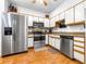 Bright kitchen with stainless steel appliances, granite countertops, and wood flooring at 1411 Sedgwick Dr, Wesley Chapel, FL 33543