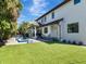 Spacious backyard with well-manicured lawn, pool, covered patio, and elegant landscaping; ideal for relaxation and entertainment at 150 Chippewa Ave, Tampa, FL 33606