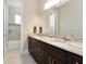 A spacious bathroom featuring a double sink vanity with dark cabinets and a tub/shower combo at 150 Chippewa Ave, Tampa, FL 33606