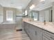 Luxurious bathroom featuring a large vanity with double sinks, a soaking tub, and a glass-enclosed shower at 150 Chippewa Ave, Tampa, FL 33606
