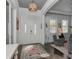 Inviting foyer with a decorative rug, elegant light fixture, and double doors with glass panels at 150 Chippewa Ave, Tampa, FL 33606