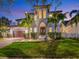 Stunning two-story home with well-manicured lawn and lush landscaping, showcasing an elegant architectural style and a welcoming entrance at 150 Chippewa Ave, Tampa, FL 33606