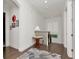 Bright hallway featuring dark hardwood floors, a decorative table, and stairway at 150 Chippewa Ave, Tampa, FL 33606
