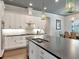 Kitchen featuring a large island with seating, stainless steel appliances, and white cabinetry at 150 Chippewa Ave, Tampa, FL 33606