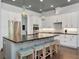 Spacious kitchen featuring a large island with seating, pendant lighting, and stainless steel appliances at 150 Chippewa Ave, Tampa, FL 33606