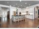 Bright, open kitchen with white cabinets, large island with seating, and modern stainless steel appliances at 150 Chippewa Ave, Tampa, FL 33606