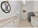 Bright and clean laundry room with sink, cabinetry, washer, and dryer at 150 Chippewa Ave, Tampa, FL 33606