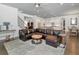 Open-concept living room with hardwood floors, staircase, and view to the kitchen at 150 Chippewa Ave, Tampa, FL 33606