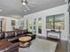 Open-concept living room with a comfortable sectional, access to a patio, and natural light at 150 Chippewa Ave, Tampa, FL 33606
