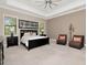 Spacious main bedroom with tray ceilings, two windows, and two armchairs at 150 Chippewa Ave, Tampa, FL 33606