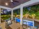 Outdoor entertainment area with a bar, seating overlooks the pool and backyard landscaping, perfect for relaxing and entertaining at 150 Chippewa Ave, Tampa, FL 33606