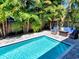 Outdoor entertainment area with a pool and seating surrounded by lush landscaping, creating a private oasis at 150 Chippewa Ave, Tampa, FL 33606