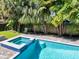 Outdoor pool with a spa and backyard surrounded by lush landscaping and creating a relaxing backyard retreat at 150 Chippewa Ave, Tampa, FL 33606