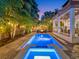 Twilight view of the sparkling pool and spa, enhanced by ambient lighting and lush tropical landscaping, perfect for evening relaxation at 150 Chippewa Ave, Tampa, FL 33606