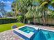 Relaxing backyard with artificial turf and a beautiful pool and spa combo, perfect for Gathering fun and outdoor entertaining at 150 Chippewa Ave, Tampa, FL 33606