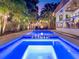 Backyard features a sparkling pool, a relaxing spa, outdoor seating, and plenty of room for enjoying the outdoors at 150 Chippewa Ave, Tampa, FL 33606