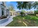 Exterior of home showing manicured backyard landscaping, pool, and gazebo at 15702 Richboro Ct, Tampa, FL 33647