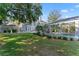 Expansive backyard with lush green lawn, landscaping, and a screened-in pool at 15702 Richboro Ct, Tampa, FL 33647