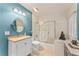 Bathroom featuring a vanity, commode, shower with glass door, and decorative shelf at 15702 Richboro Ct, Tampa, FL 33647