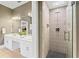 Modern bathroom featuring a shower with decorative tiling and updated vanity at 15702 Richboro Ct, Tampa, FL 33647
