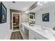 Elegant bathroom with double marble vanity, large mirror, and access to the bedroom at 15702 Richboro Ct, Tampa, FL 33647