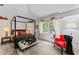 Bright bedroom featuring vaulted ceilings, a four-poster bed, and ample natural light at 15702 Richboro Ct, Tampa, FL 33647