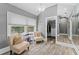 Sitting area off main bedroom, with closet, light gray paint and wood-look floors at 15702 Richboro Ct, Tampa, FL 33647