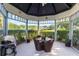 The cabana has outdoor seating and a grill overlooking the backyard at 15702 Richboro Ct, Tampa, FL 33647