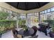 The cabana has outdoor seating and a grill overlooking the screened-in pool at 15702 Richboro Ct, Tampa, FL 33647