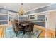 Bright dining room showcasing a wooden table, patterned chairs, and a stylish rug over the hardwood floors at 15702 Richboro Ct, Tampa, FL 33647