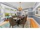 Well-lit dining room boasting a large window, wooden table, patterned chairs, and elegant decor at 15702 Richboro Ct, Tampa, FL 33647
