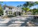 Stately two-story residence with a circular driveway, manicured lawn, and well-maintained landscaping at 15702 Richboro Ct, Tampa, FL 33647