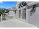 Charming exterior with white French doors, arched window, and stylish lighting fixtures at 15702 Richboro Ct, Tampa, FL 33647