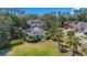 Landscaped exterior of a stunning two-story gray home featuring a screened-in pool and lush surroundings at 15702 Richboro Ct, Tampa, FL 33647