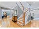 Elegant foyer showcasing a staircase, hardwood floors, and an entrance to the living room at 15702 Richboro Ct, Tampa, FL 33647