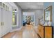 Entrance hall with hardwood floors, cabinet, and a glimpse of the living room beyond at 15702 Richboro Ct, Tampa, FL 33647