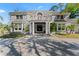 Stately two-story home featuring a beautiful double-door entrance, a large porch, and manicured landscaping at 15702 Richboro Ct, Tampa, FL 33647