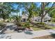 Beautifully landscaped front yard with mature trees, a quaint bench, and a glimpse of the home's facade at 15702 Richboro Ct, Tampa, FL 33647