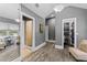 Hallway with bathroom, closet and bedroom entrances, gray paint, white trim and wood-look floors at 15702 Richboro Ct, Tampa, FL 33647