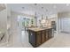 Bright and open kitchen with a large island, stainless steel appliances, and a breakfast nook with backyard views at 15702 Richboro Ct, Tampa, FL 33647