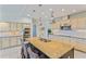 Kitchen featuring an island with seating and stainless steel appliances and pendant lights at 15702 Richboro Ct, Tampa, FL 33647