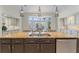Spacious kitchen island with granite countertops and stainless steel appliances at 15702 Richboro Ct, Tampa, FL 33647