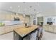 Large kitchen featuring an island with seating, stainless steel appliances, and pendant lighting at 15702 Richboro Ct, Tampa, FL 33647
