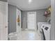 Functional laundry room with an ironing board and extra storage space at 15702 Richboro Ct, Tampa, FL 33647